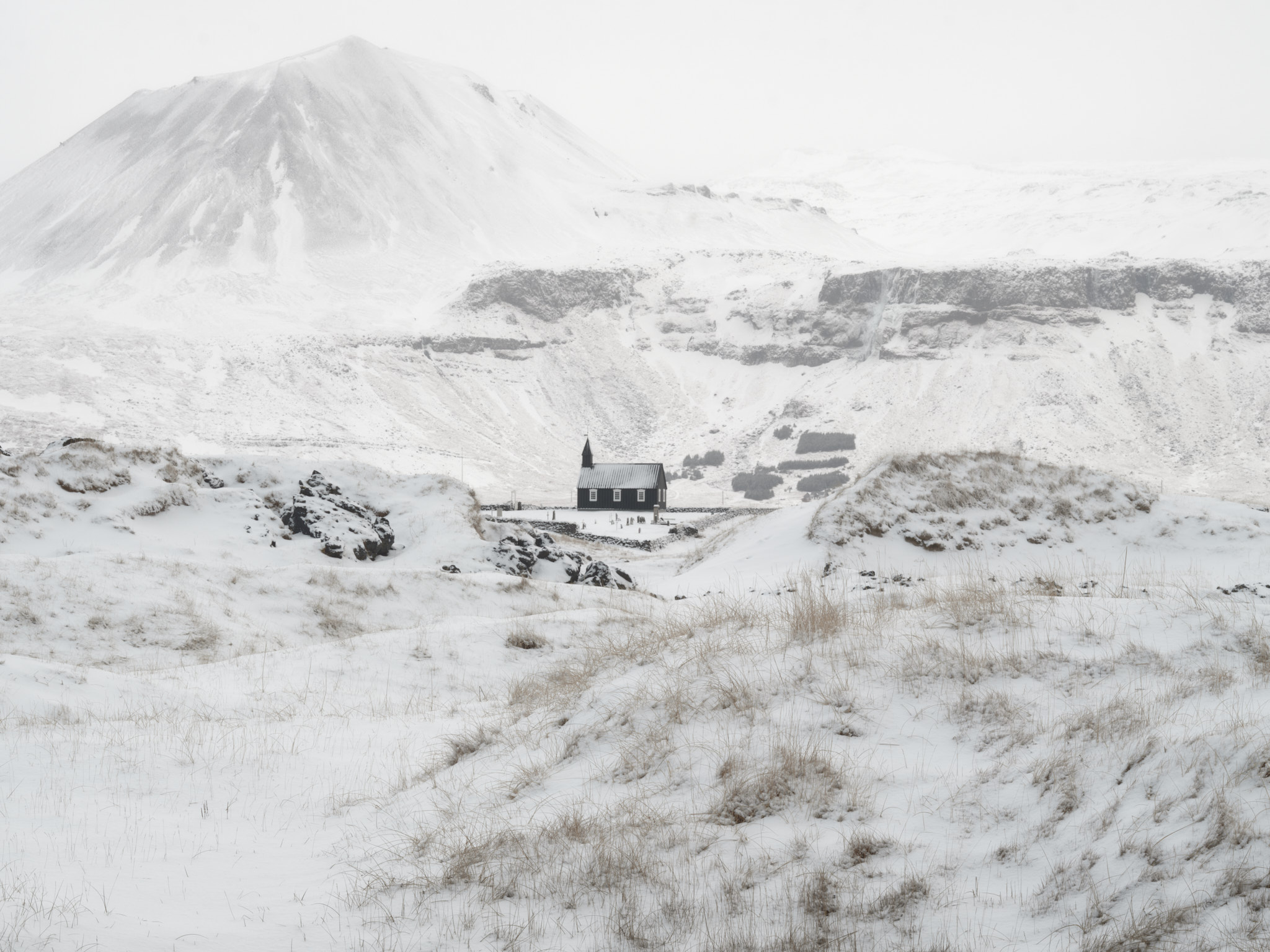 Búðakirkja church and mountains covered in snow