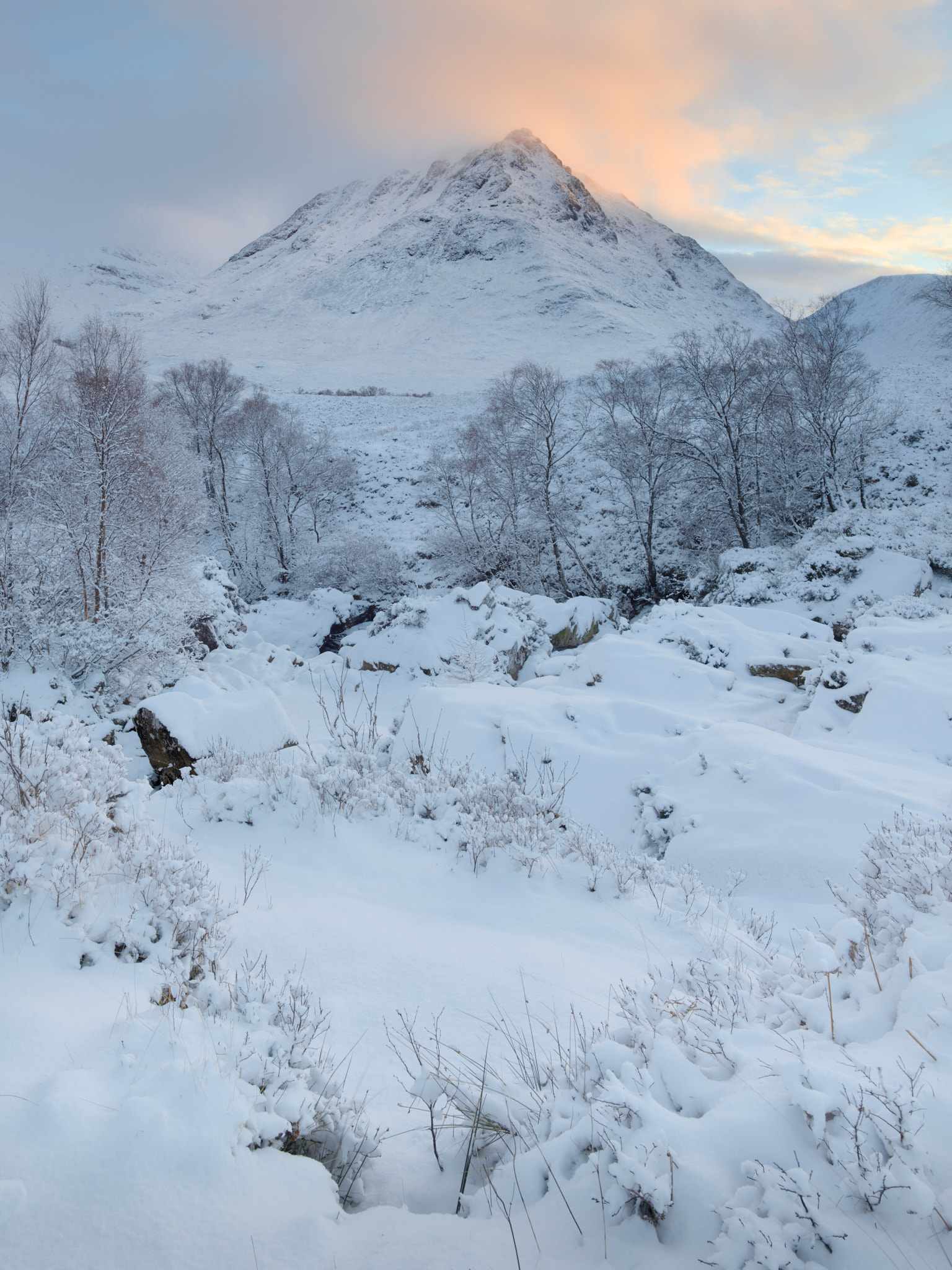 Stob a’ Ghlais Choire above snow-covered birches and moor at sunset