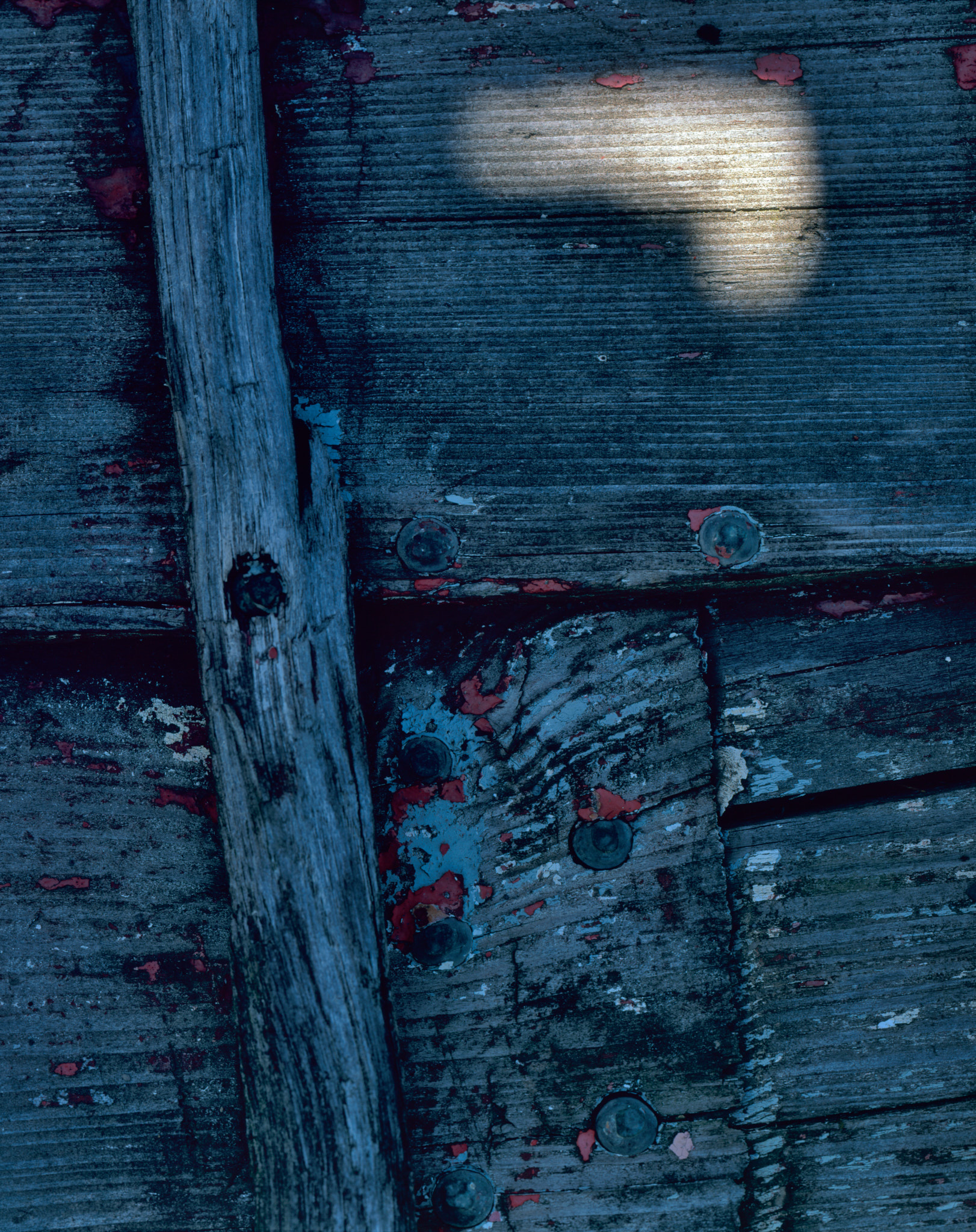 A gleam of light on a shadowed boat
