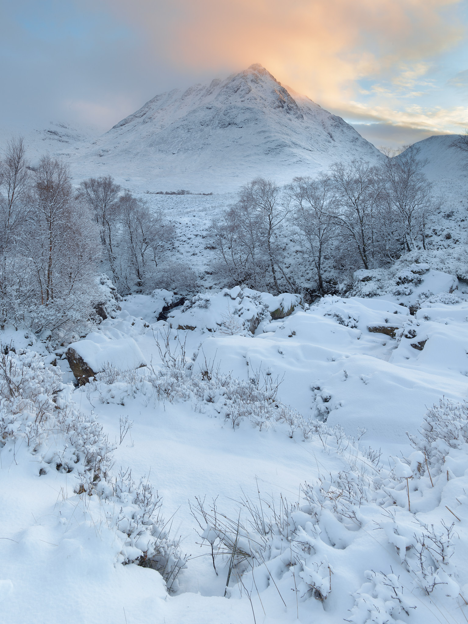 Snow capped hill at sunset on Rannock Moor